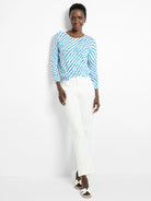 Blue and white patterned, long-sleeved sweater.  The pattern is a swirling design.