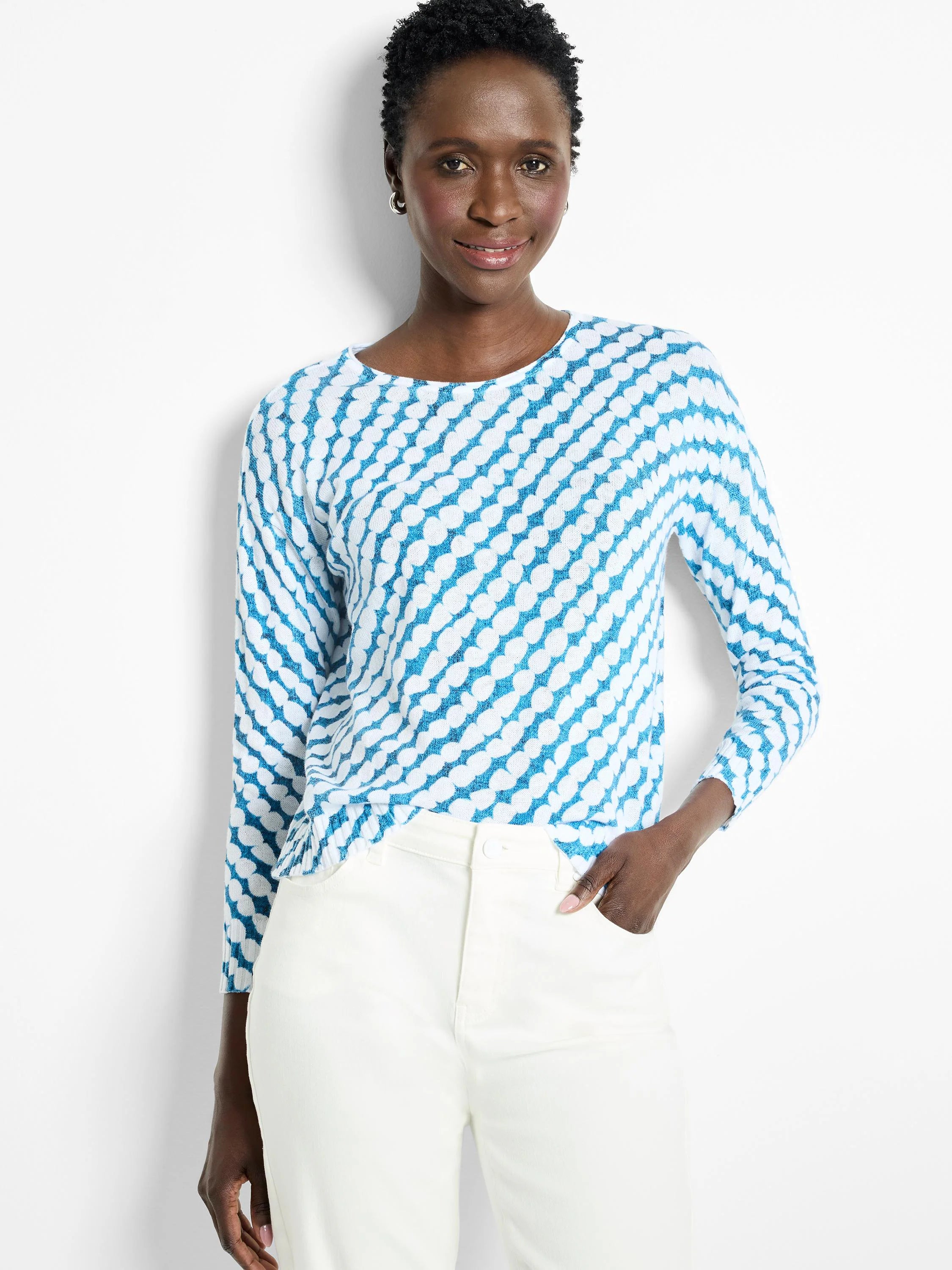 Teal and white patterned sweater.  Three-quarter sleeves, crew neck.  Diagonally oriented pattern of small, rounded shapes.