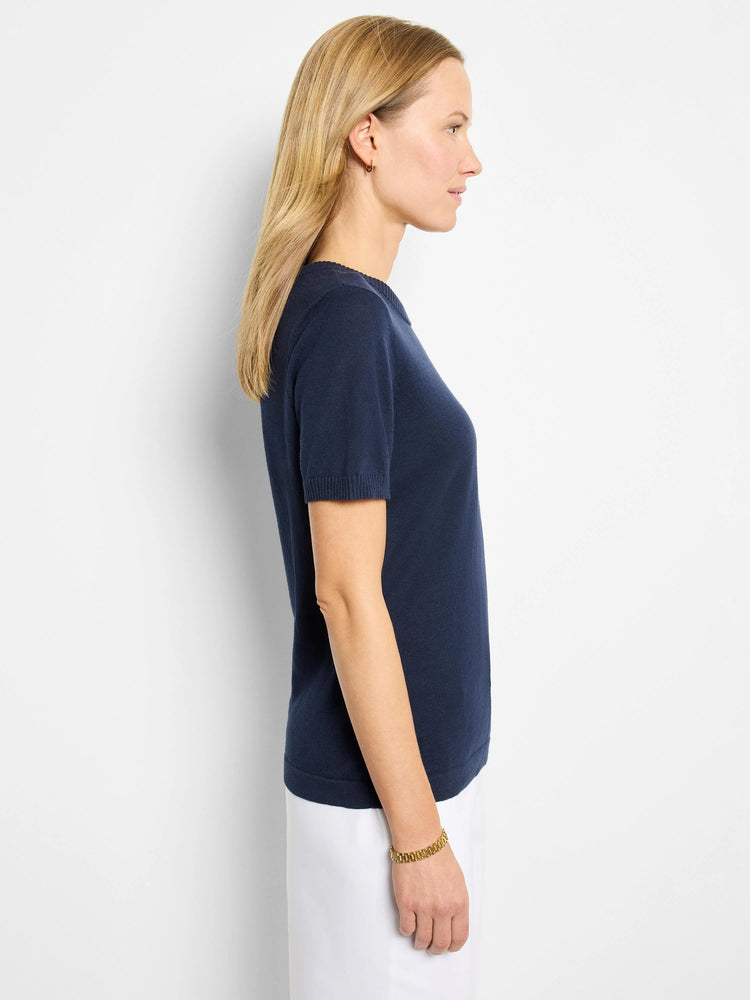 Navy blue, short-sleeved scoop neck cotton sweater tee.  Side profile view.