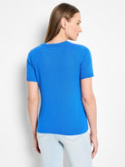 Back view of bright blue, short-sleeved cotton sweater tee.