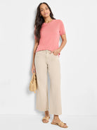 Pink scoop-neck cotton sweater tee with short sleeves.  Model shown wearing it.