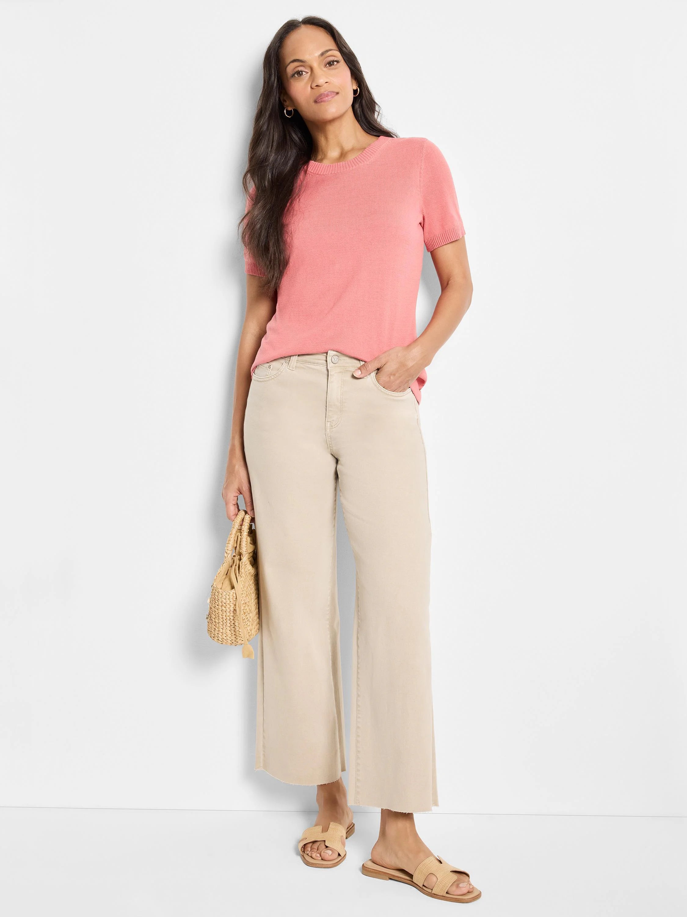 Pink scoop-neck cotton sweater tee with short sleeves.  Model shown wearing it.