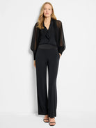 Black sheer chiffon cardigan,  loose sleeves, over black top & pants.  Wide-leg pants with satin waistband.