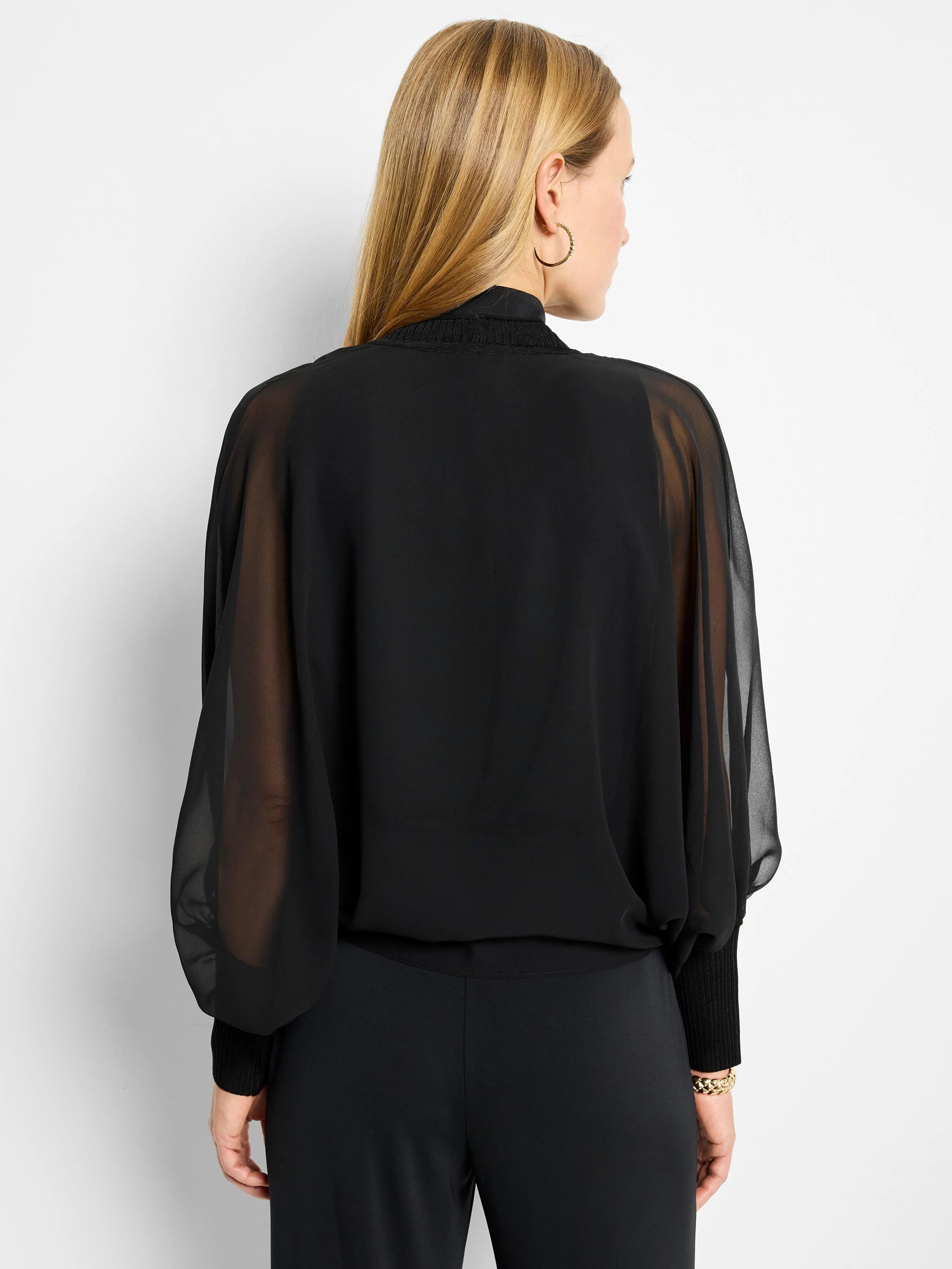 Black sheer chiffon cardigan with balloon sleeves and ribbed knit cuffs.  Back view.