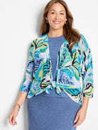 4-way cardigan; blue, green, & black leaf print on light blue background.  Three-quarter sleeves.  Front ties at waist.