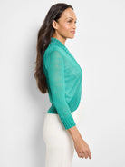 Sheer aqua green bolero cardigan with 3/4 sleeves, ribbed cuffs, and an open front. Cropped length.