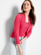 Fuchsia pink bolero cardigan with long sleeves, a ribbed shawl collar, and a single front button closure.