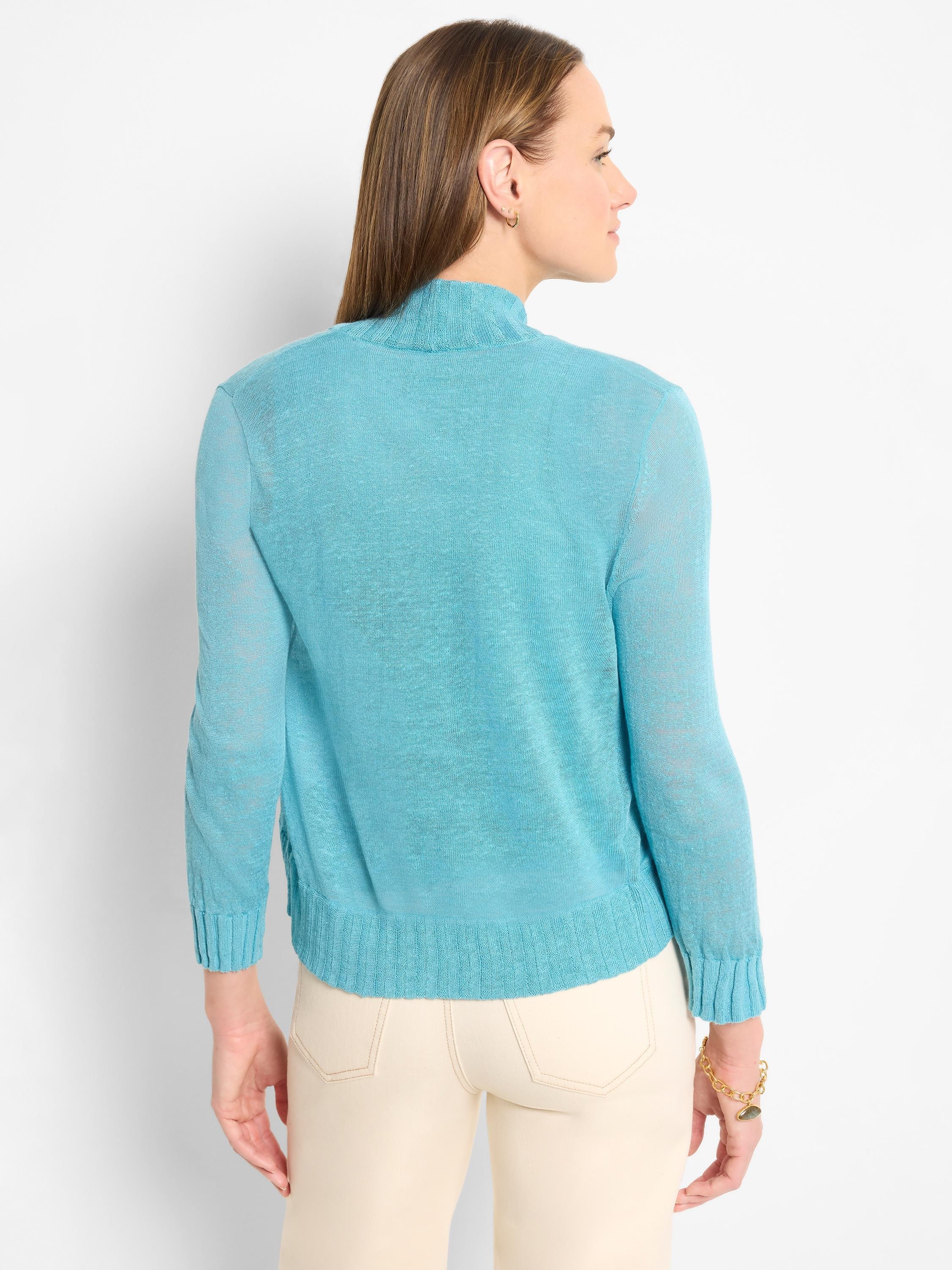 Bright blue bolero cardigan with mock neck, long sleeves, and a fine, lightweight knit. Ribbed cuffs and hem.