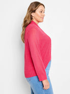Bright pink open-front bolero cardigan with long sleeves, lightweight knit, and ribbed cuffs and hem.