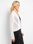 White open-knit mesh cardigan with a draped cocoon shape and long sleeves, worn open.