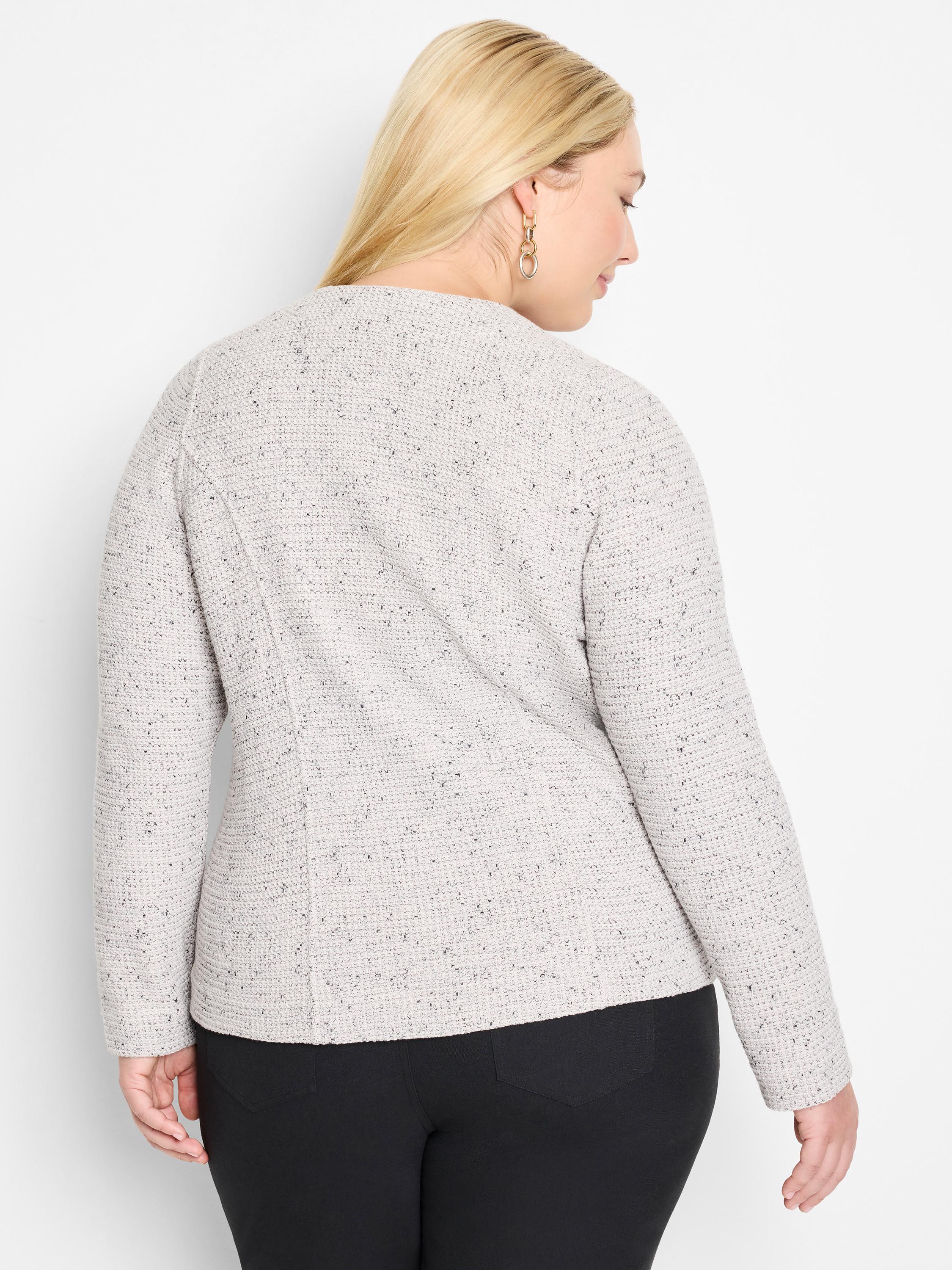 The model wears a tailored, long-sleeve, collarless jacket in a light grey tweed knit with black speckles.