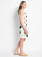 Off-white crochet sleeveless dress.  Features black and beige diamond pattern.