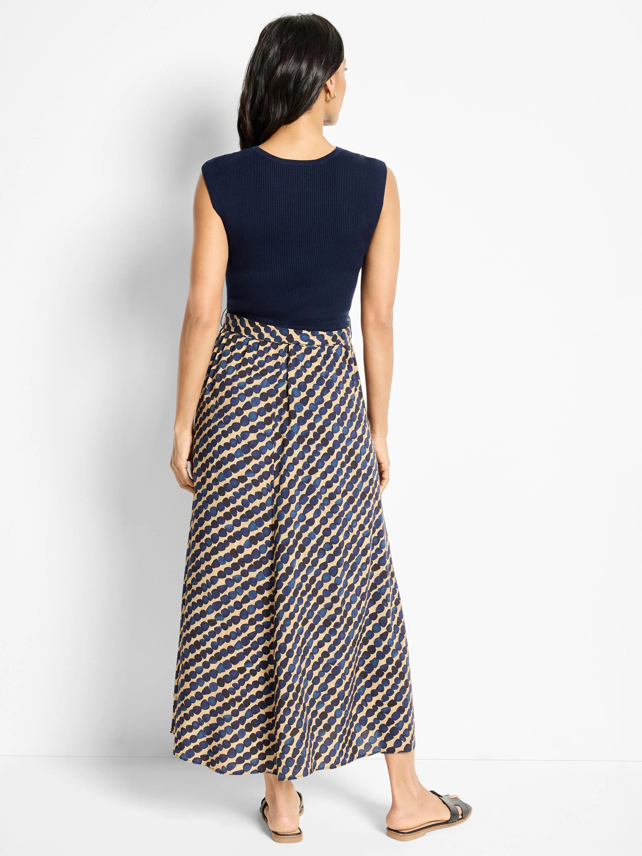 Maxi dress; beige background with dark blue, pebble-like pattern.  Navy sleeveless top.
