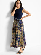 Navy blue ribbed top, tan and navy blue patterned maxi skirt with a self-tie belt.