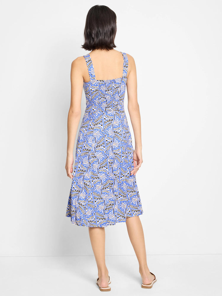 Blue midi dress with a  beige and black geometric print. Sleeveless, square neckline. Back view.