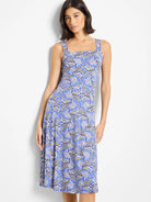 Blue midi dress with a geometric print in beige and black. Square neckline and thin straps. A-line skirt.