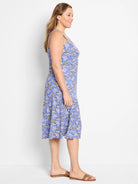 Blue midi dress with a sleeveless, scoop neck, and a beige, black, and white geometric print.