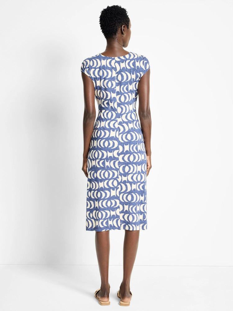 Blue midi dress with cream-colored crescent moon pattern, short sleeves, and a V-neck.
