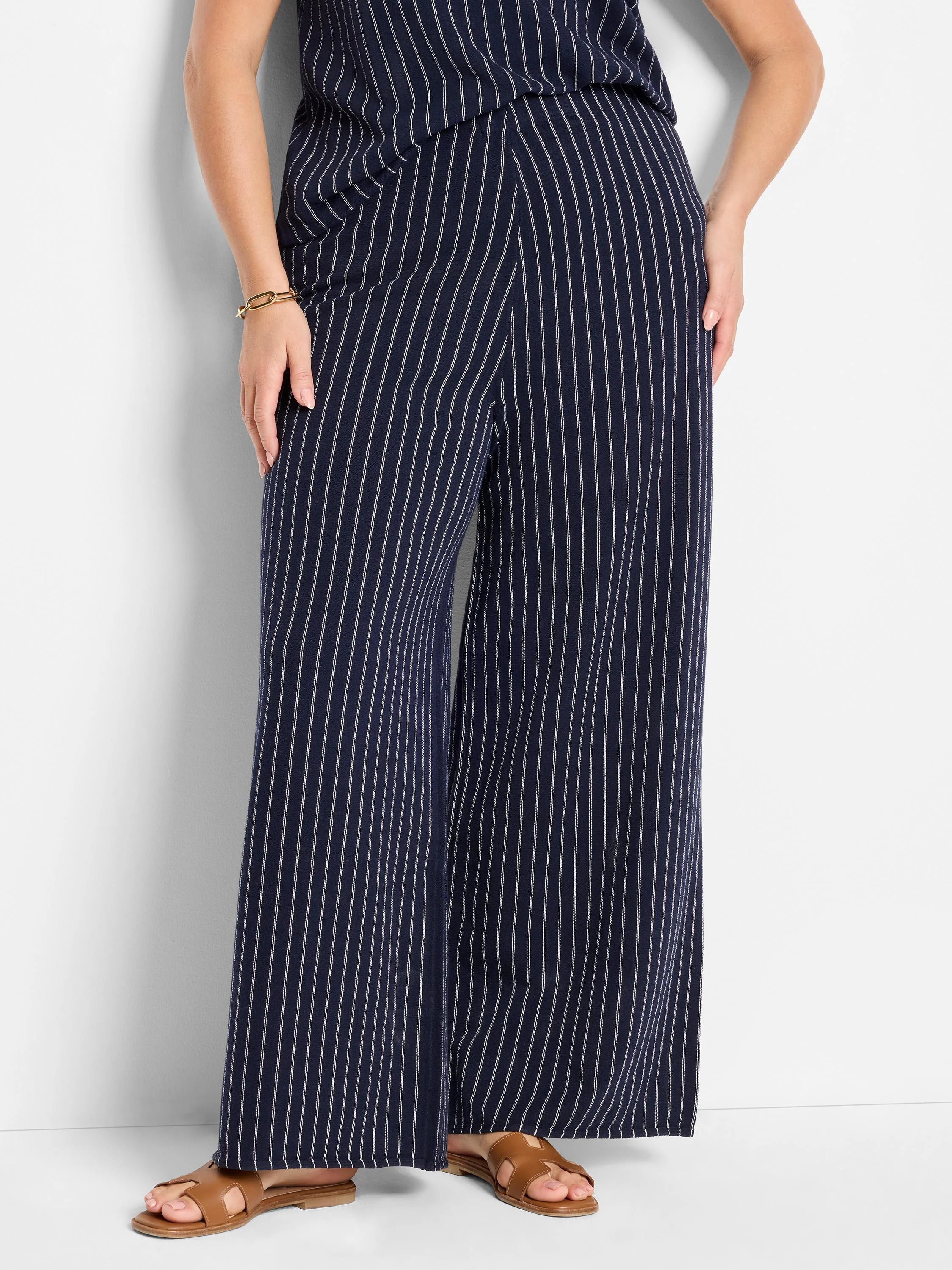 Wide-leg pants; navy blue with thin white pinstripes.