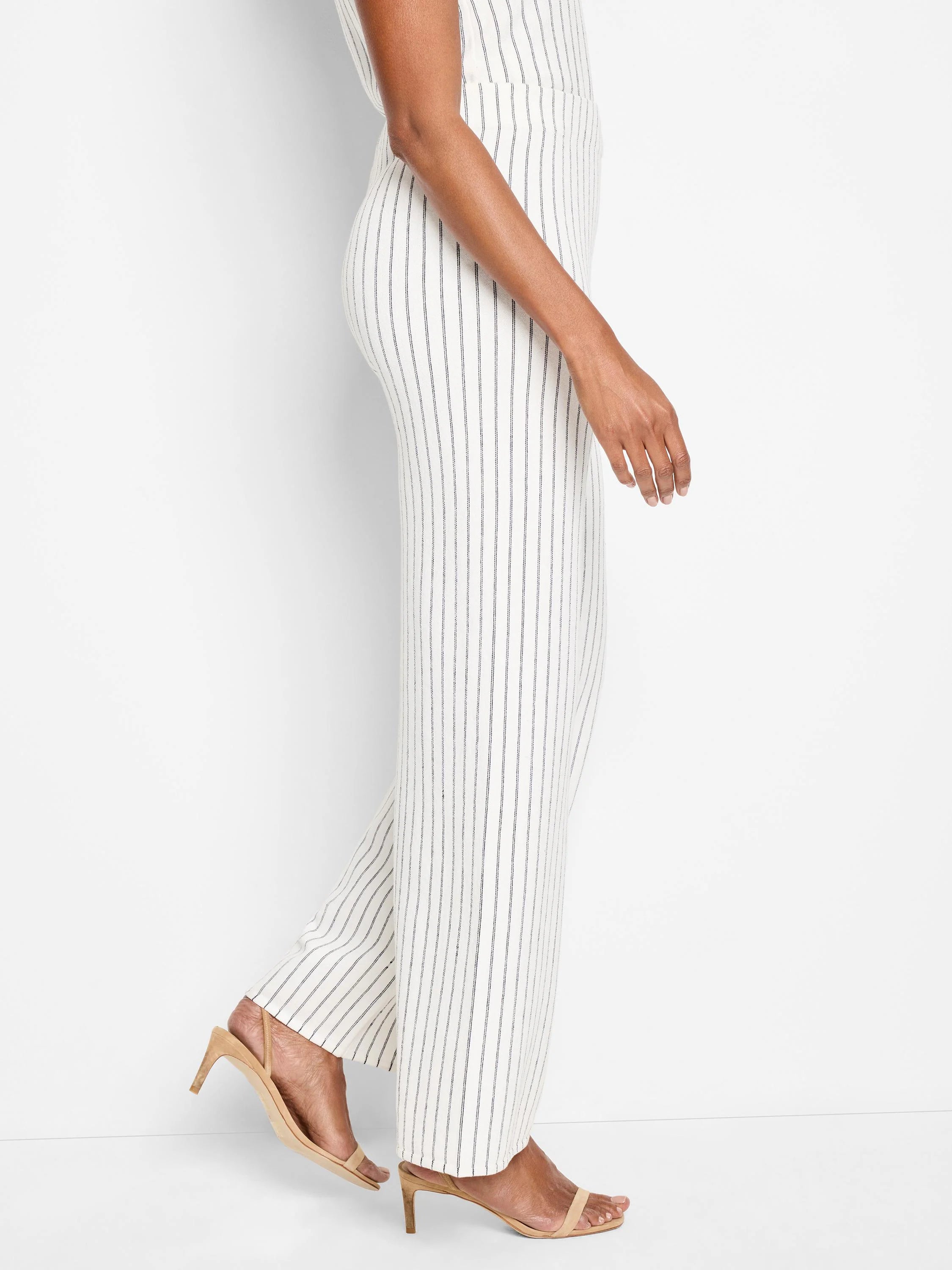 Off-white wide-leg pants with thin, dark-blue vertical stripes. Shown on a model.