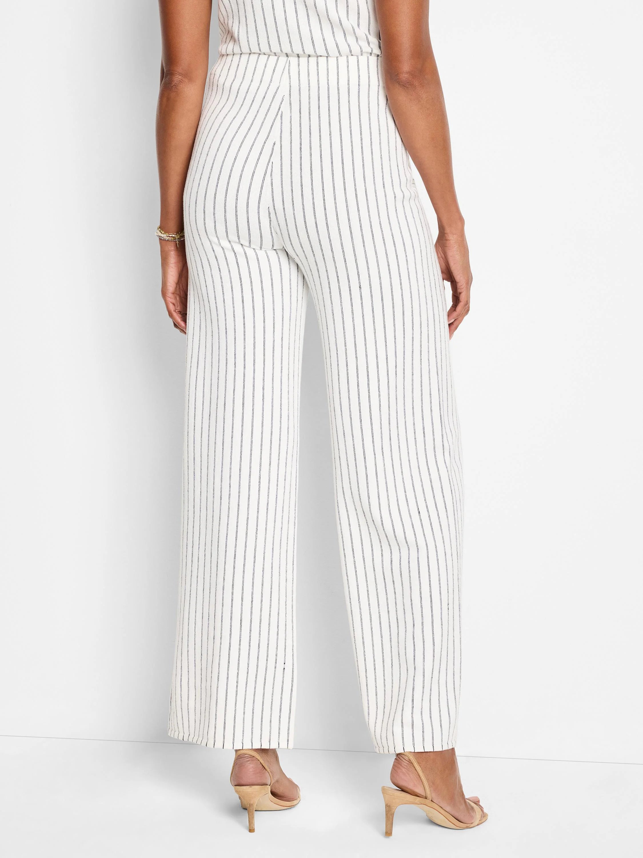 Image of wide-leg pants; off-white with thin, dark-blue vertical stripes.  Rear view.