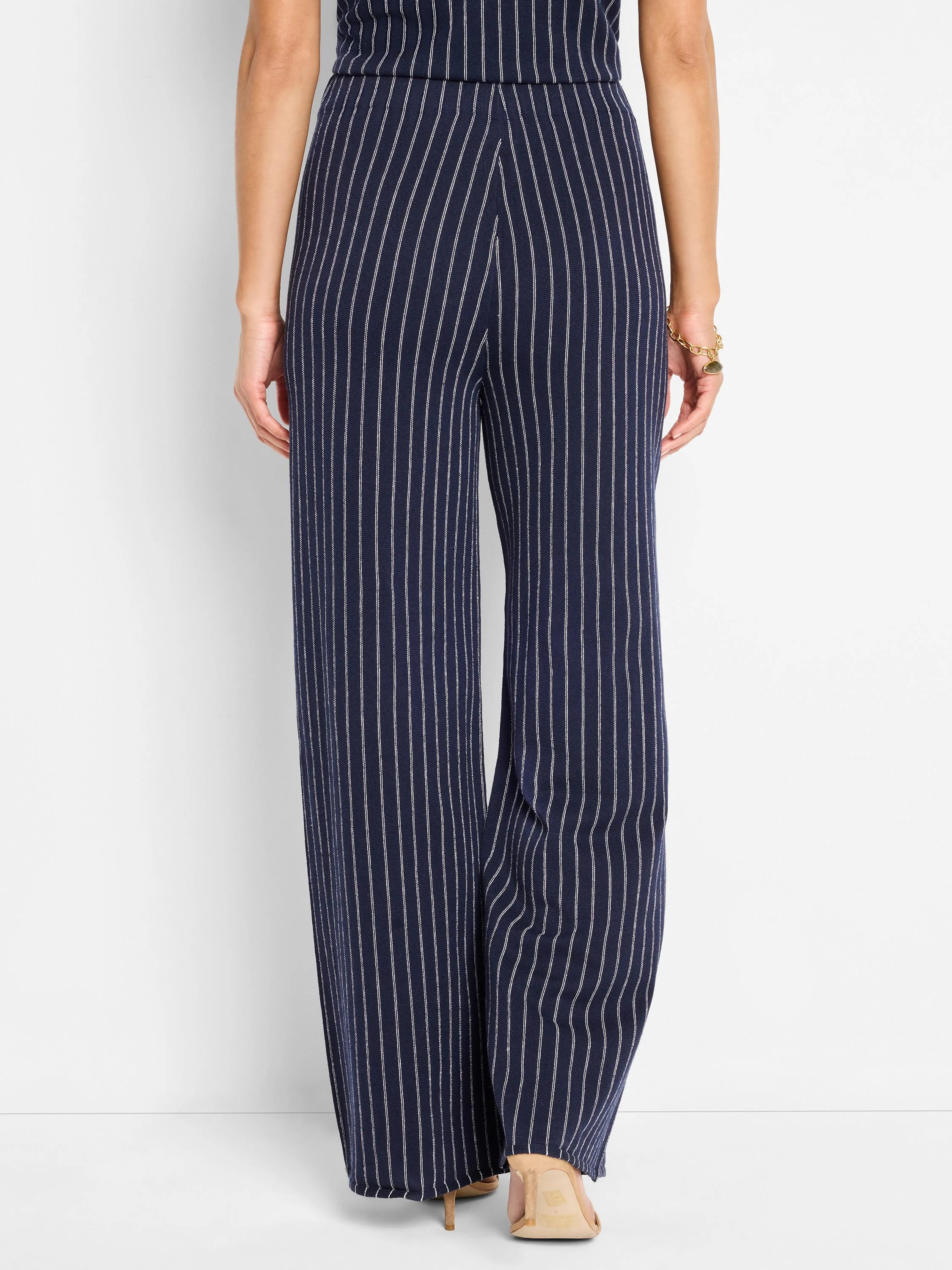 Navy blue wide-leg pants with thin white vertical stripes.  Knit fabric.