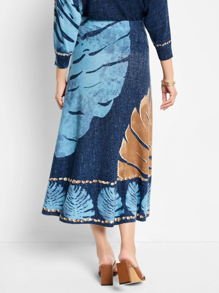 A-line midi skirt in blue and brown, featuring a leaf print and a beaded hem.