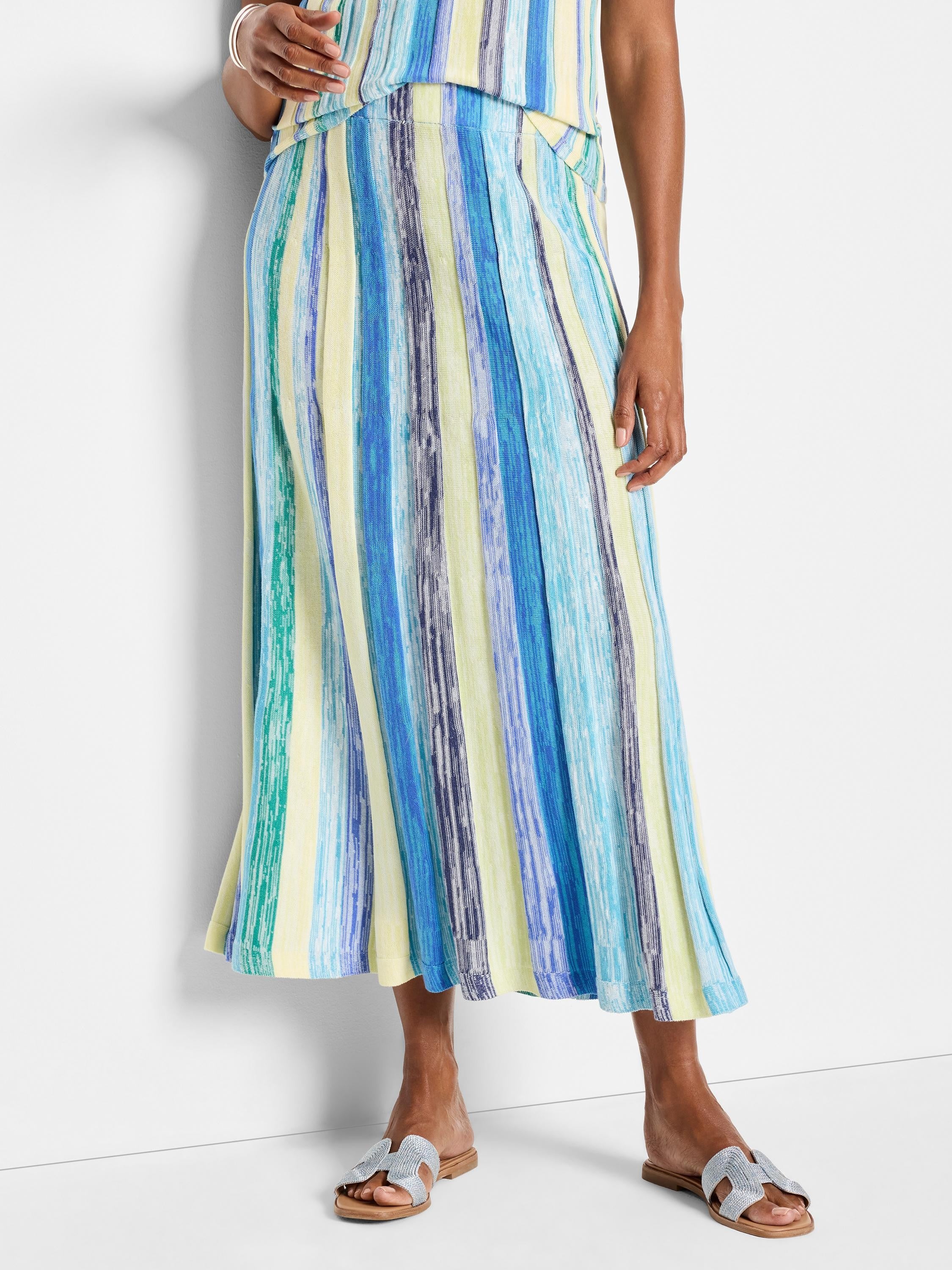 Knit midi skirt with vertical stripes in blues, greens, and pale yellow. Pleated.