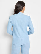 Light blue denim blazer, long sleeves,  collared.  Seen from the back.