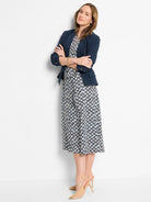 Navy blazer,  white & navy geometric-print midi dress.  Beige heels.