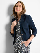 Navy blue blazer, double pockets, single button.  Features long sleeves and a slightly fitted silhouette.