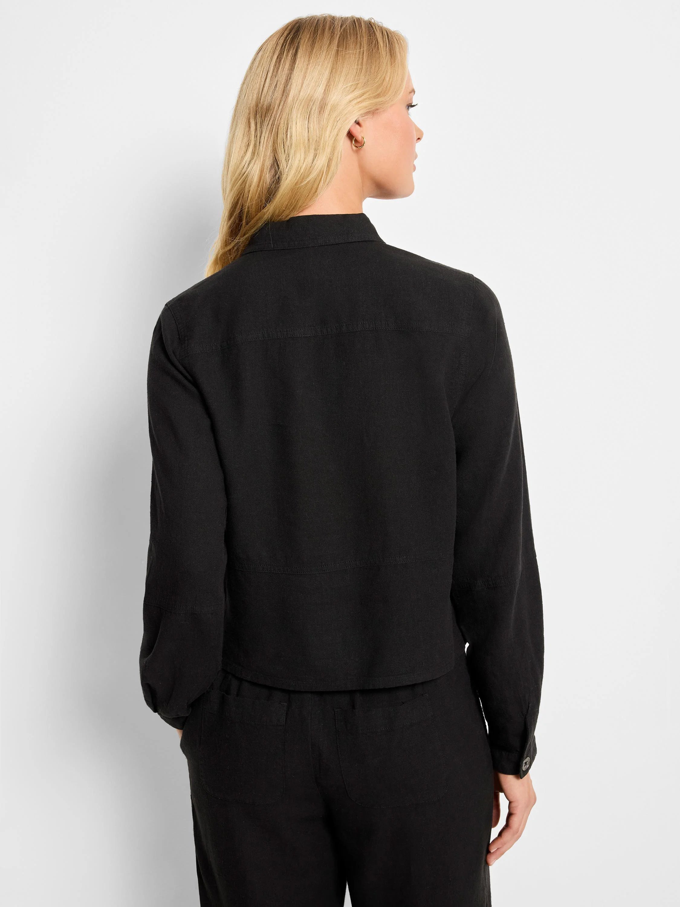 Black linen jacket, collared, long sleeves with button cuffs, and patch pockets.  Rear view.