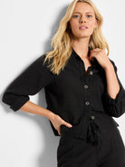 Black linen pocket jacket with button front, three-quarter sleeves, and a drawstring tie at the waist.  Features flap...
