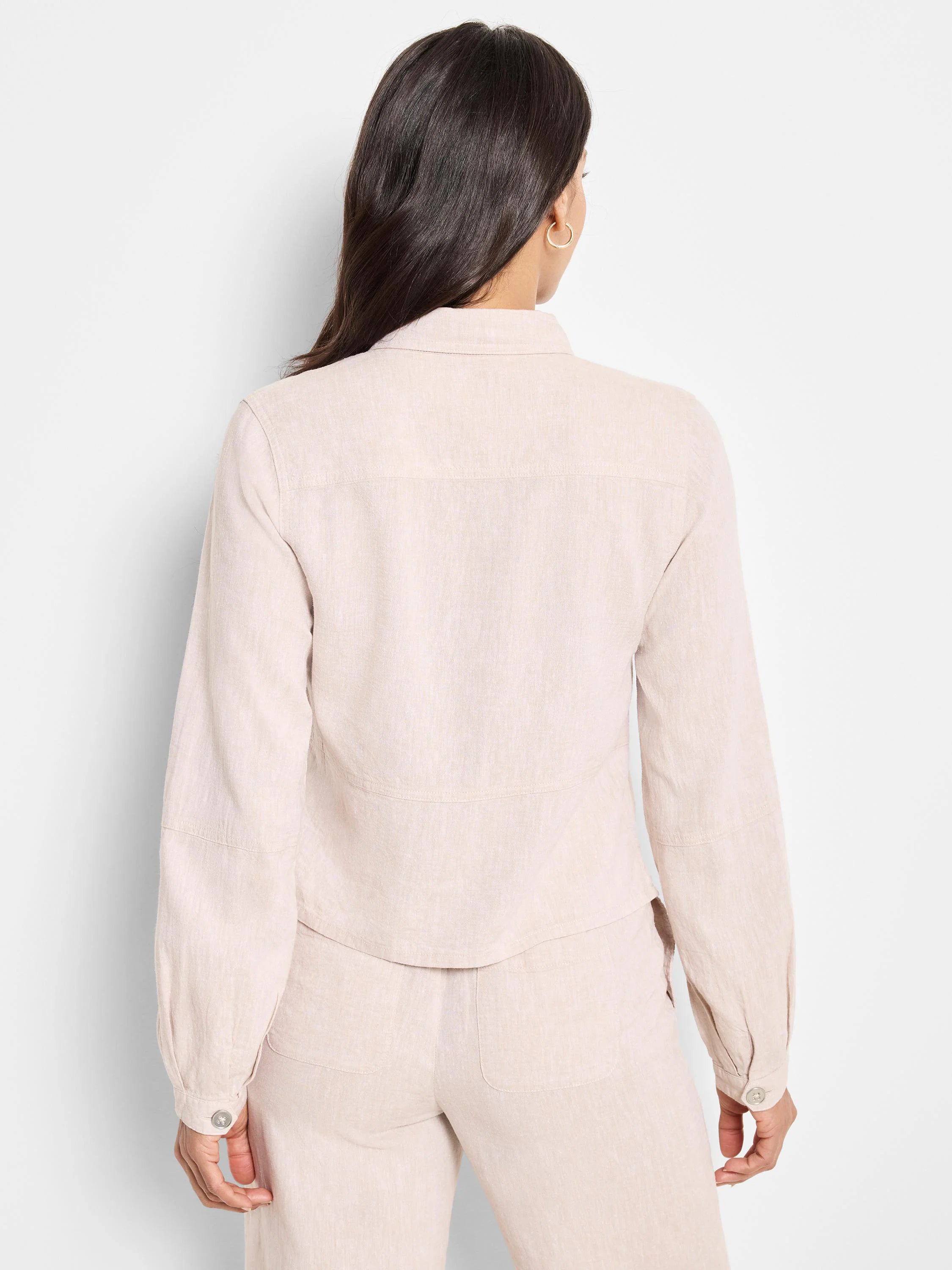 Beige linen jacket, long sleeves, button cuffs,  collared.  Shown from the back.