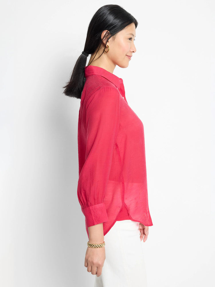 Crimson red, collared, long-sleeve shirt with slightly puffed sleeves and a curved hemline.
