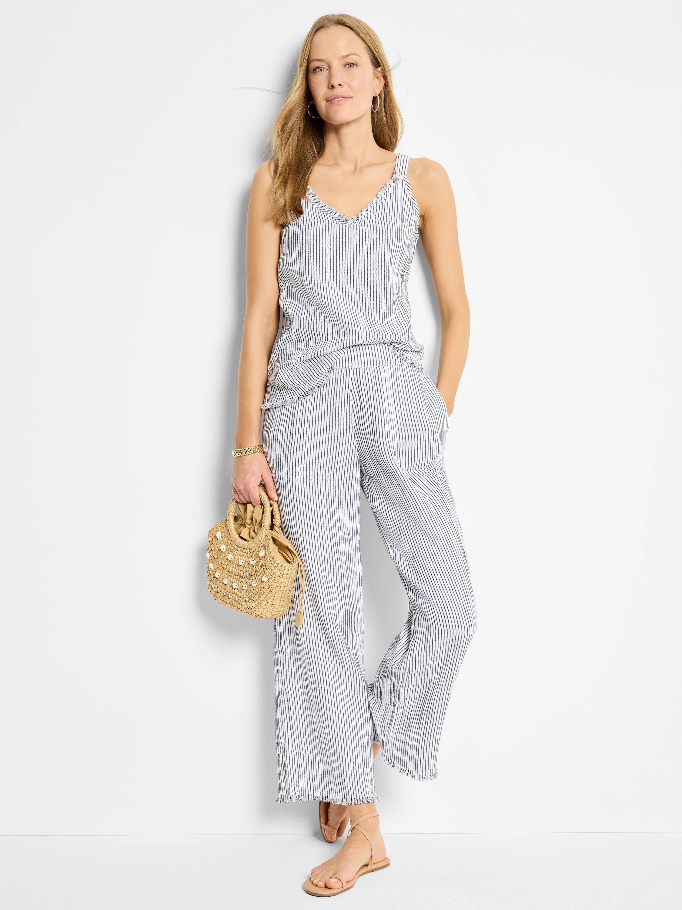 White tank top with thin, dark blue pinstripes; V-neck and frayed edges.