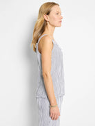 White tank top with thin navy pinstripes, frayed edges at neckline and hem.  Sleeveless, spaghetti straps.