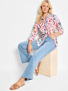 Cotton shirt with abstract pink, blue, and orange pattern on an off-white background.  Long sleeves, collared.