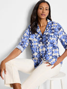 Blue and off-white tie-dye pattern long-sleeve button-up shirt with chest pockets.