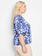 Blue and beige tie-dye pattern, 3/4 sleeves, collared shirt.