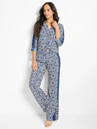 White shirt and pants with navy blue geometric pattern and vertical stripes.  Three-quarter sleeves.