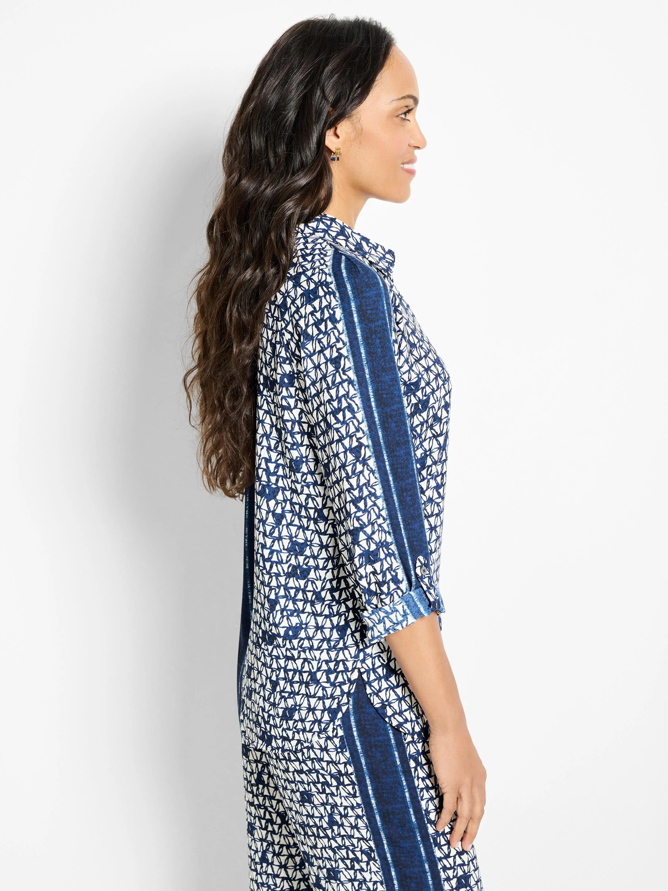 Blue and white patterned shirt;  geometric design with vertical stripes.  Three-quarter sleeves, collared.
