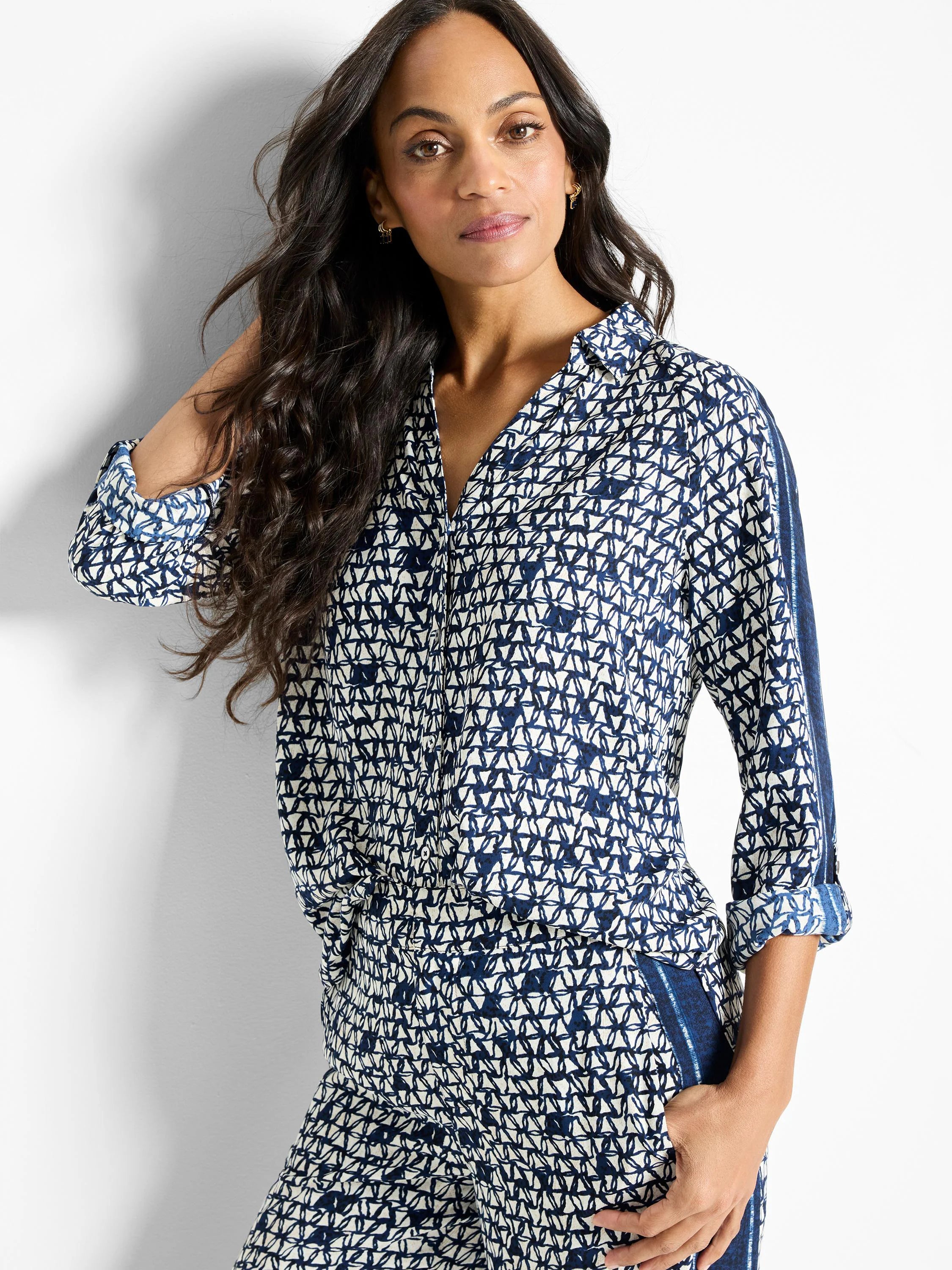 Off-white shirt with navy blue geometric pattern.  Three-quarter sleeves, collared.  Side panels in darker blue.