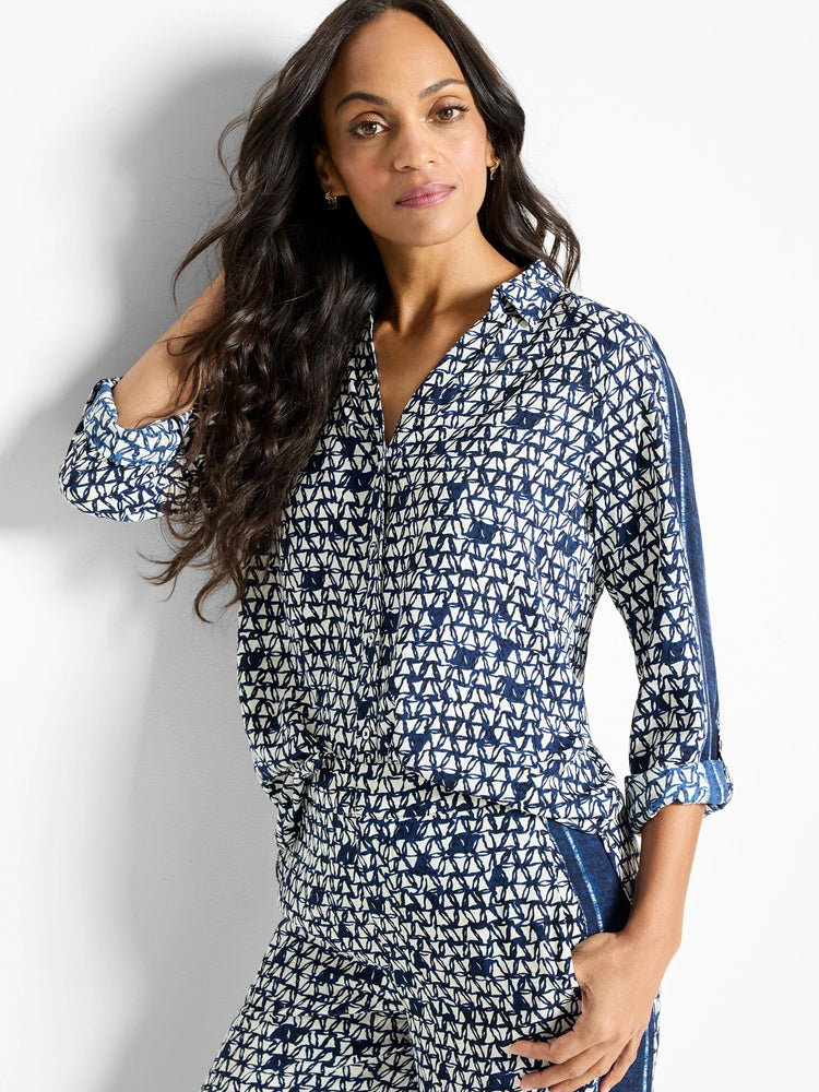 Off-white shirt with navy blue geometric pattern.  Three-quarter sleeves, collared.  Side panels in darker blue.