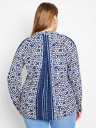 White shirt with navy blue geometric pattern and vertical stripes down the back. Long sleeves.