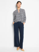 White shirt with navy and black geometric basketweave pattern; three-quarter sleeves, collared.