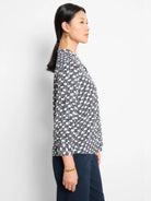 Off-white shirt with a geometric pattern in navy and black.  Three-quarter sleeves.