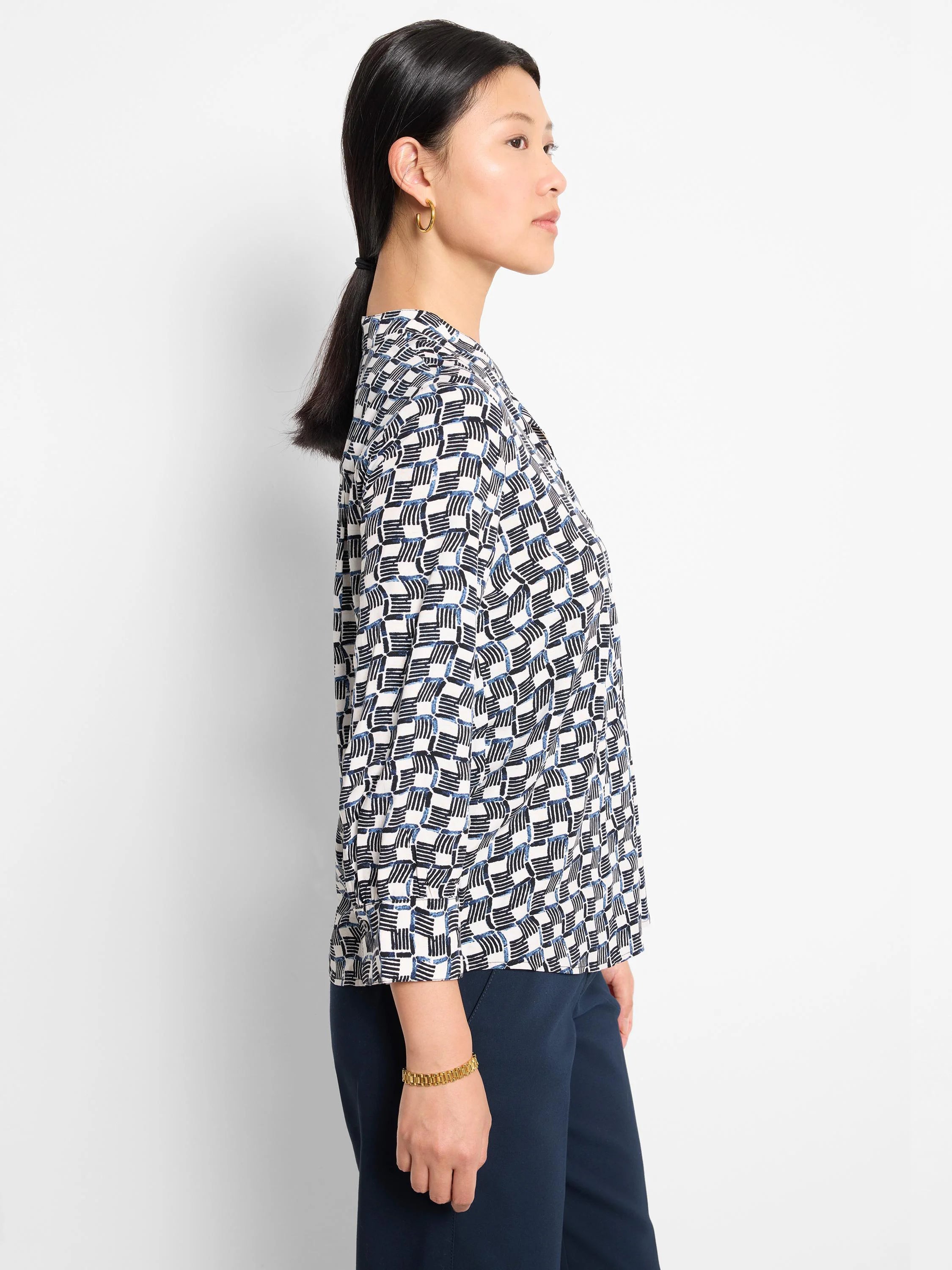 Off-white shirt with a geometric pattern in navy and black.  Three-quarter sleeves.