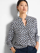 Off-white shirt with a geometric pattern in navy and dark blue. Three-quarter sleeves, V-neck.