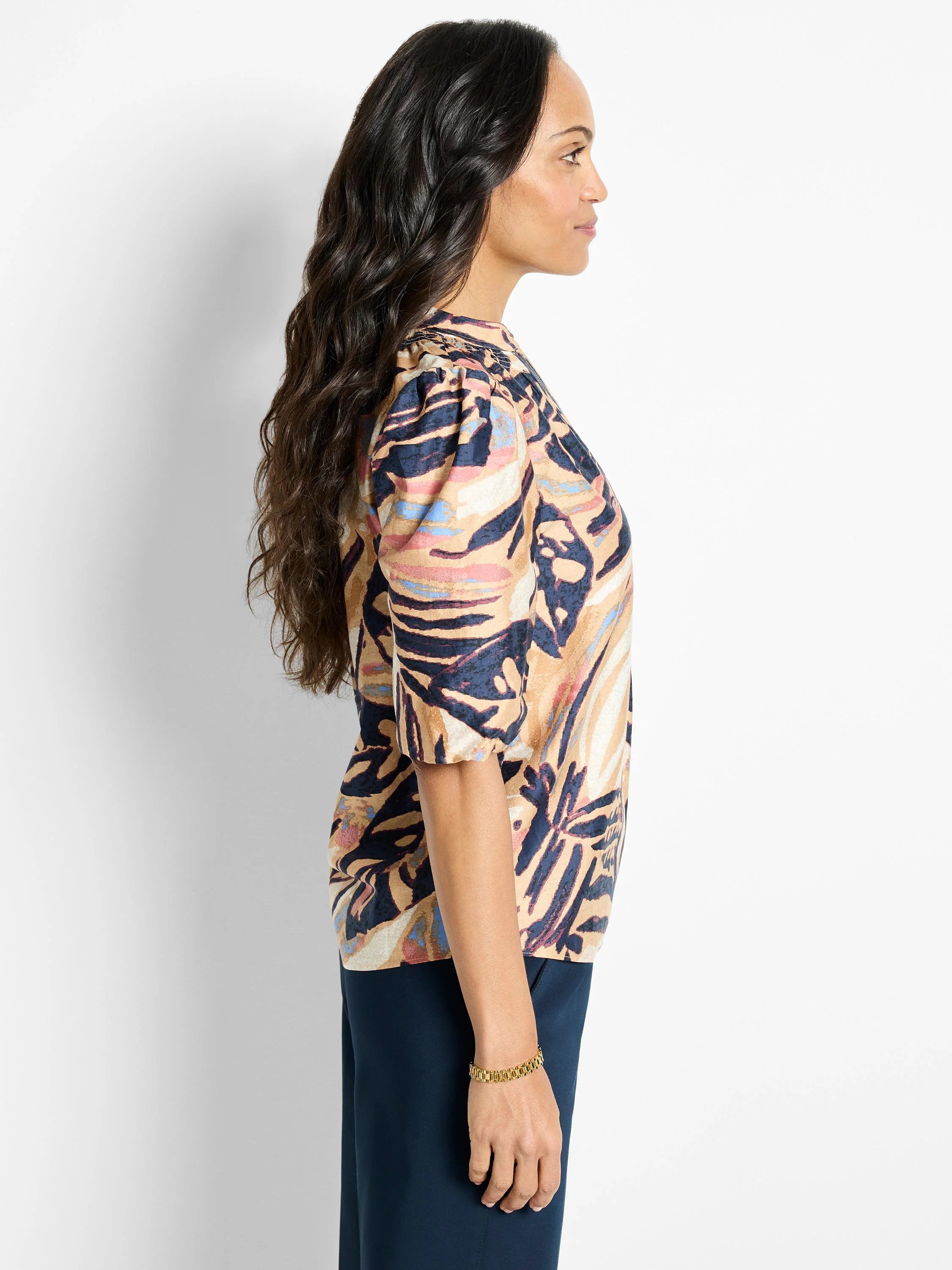 Terracotta top with abstract navy, beige, and pink leaf print.  Three-quarter sleeves, puff shoulders.